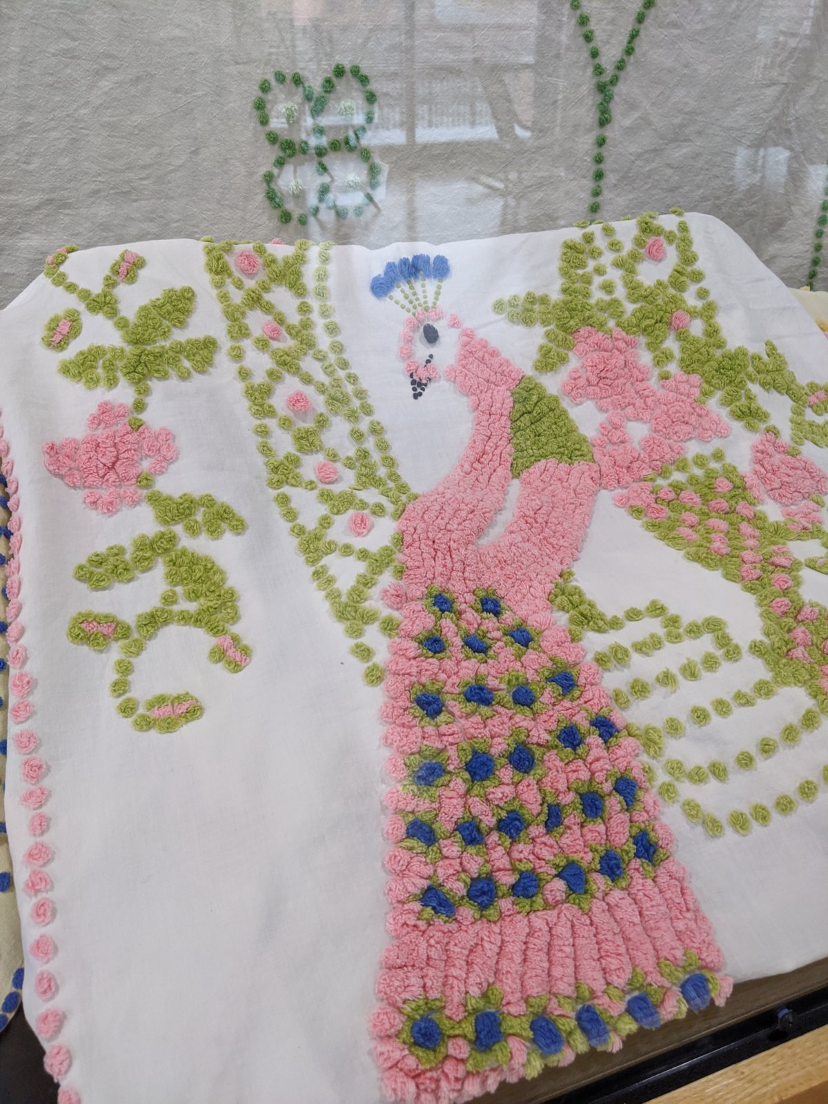 Two peacock chenille bedspreads (yellow ground; white ground with pink peacock)
